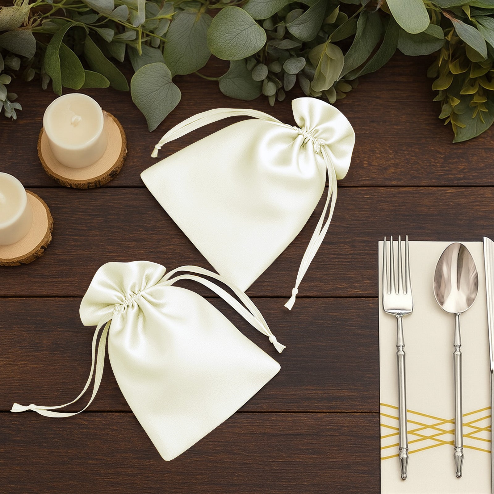 White satin drawstring wedding favor gift bags on wooden table