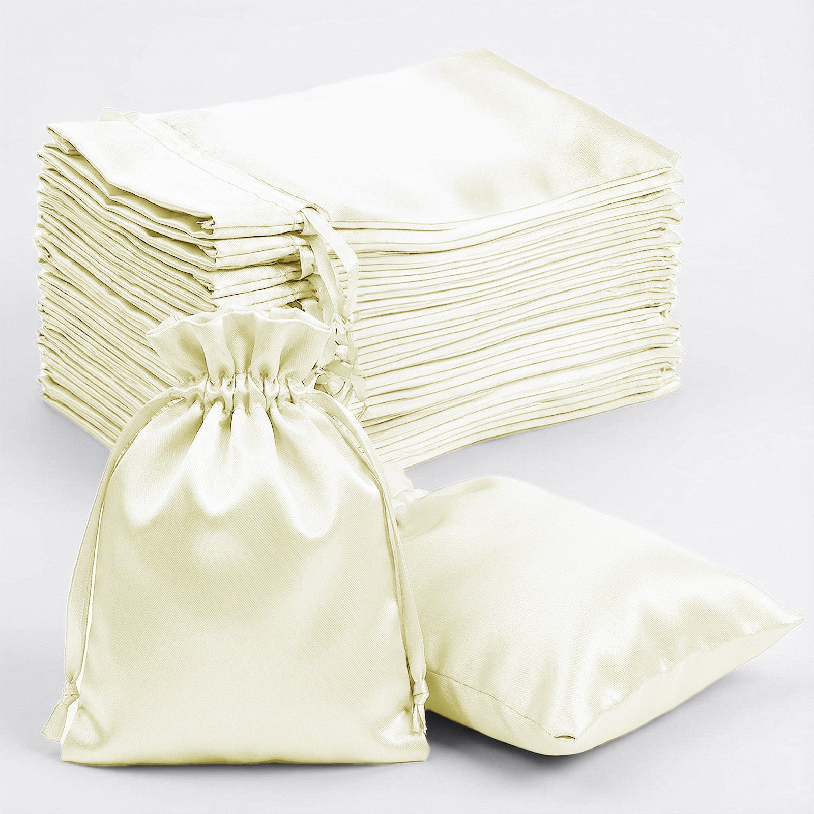 Yellow satin drawstring gift bags, perfect for wedding party favors.
