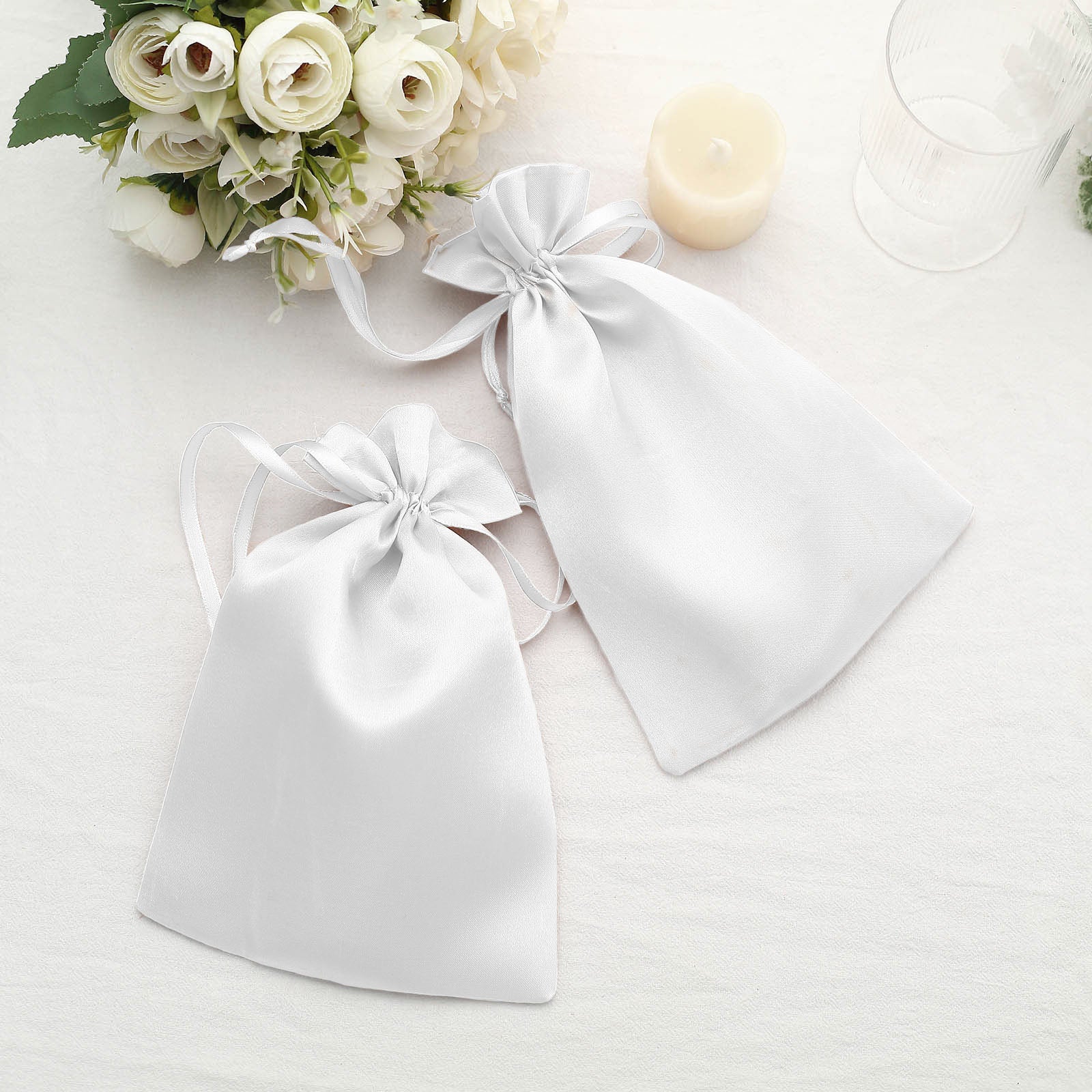 White satin drawstring gift bags for weddings and parties. Pack of 60.