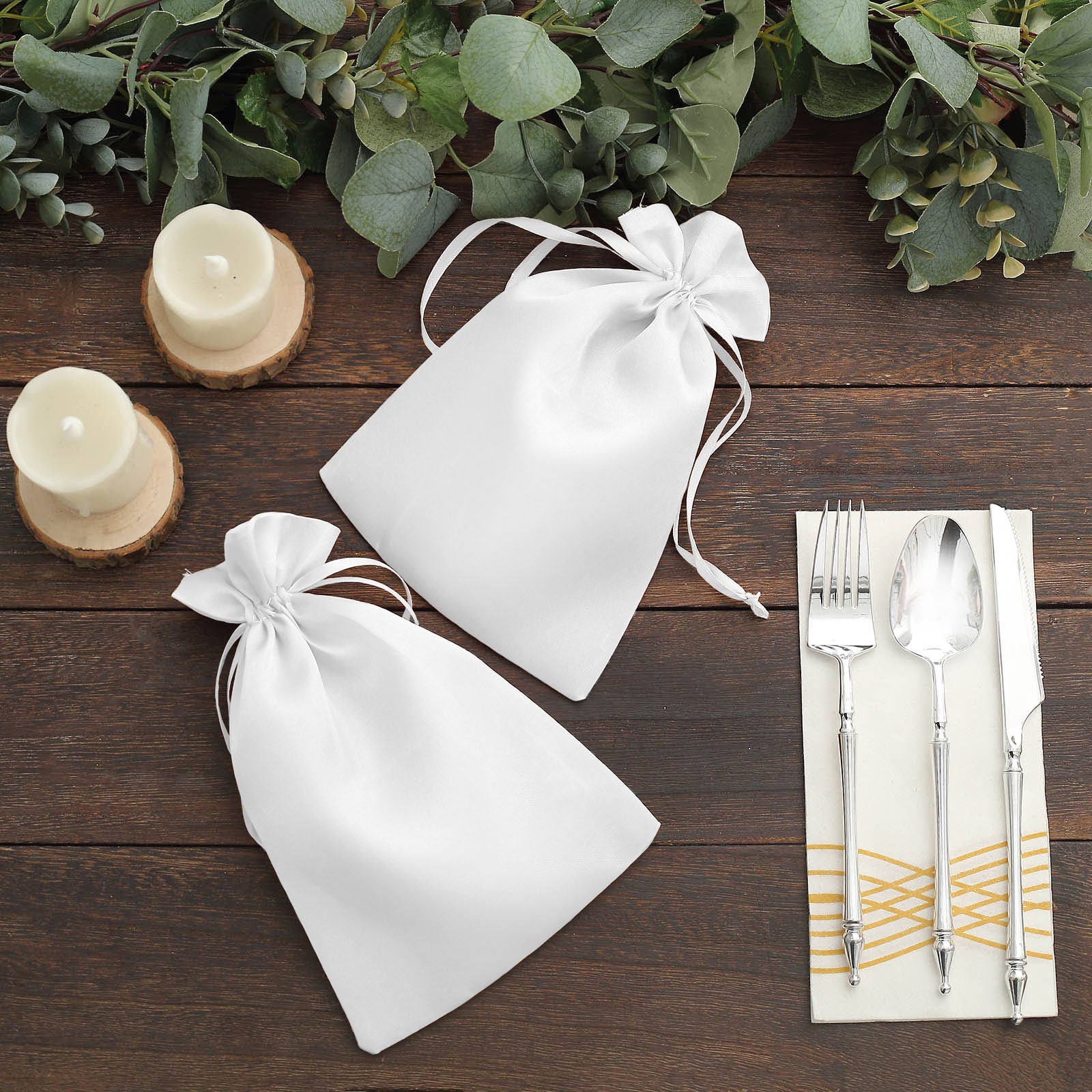 White satin drawstring gift bags for wedding party favors.