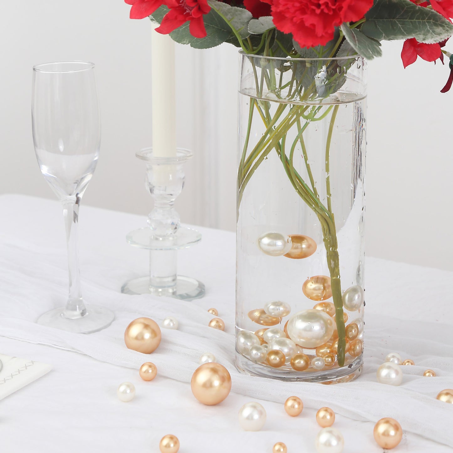 Assorted off white and gold faux pearl beads in a vase setting.