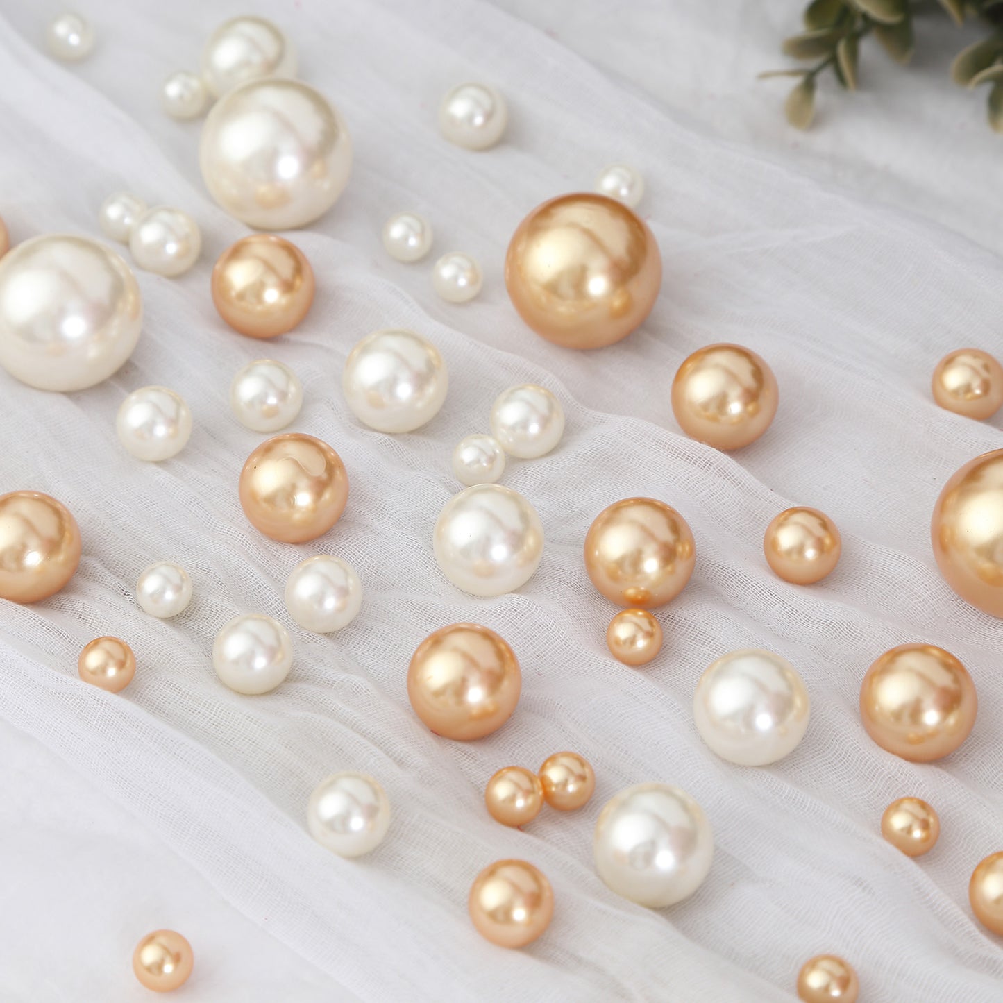 Assorted off white and gold faux pearl beads for DIY crafts.