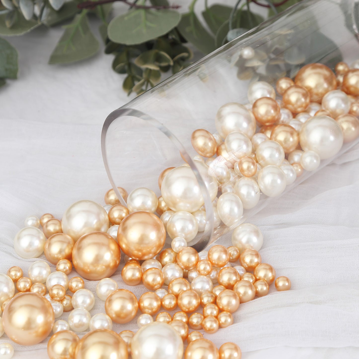 Assorted off white and gold faux pearl beads for DIY crafts.