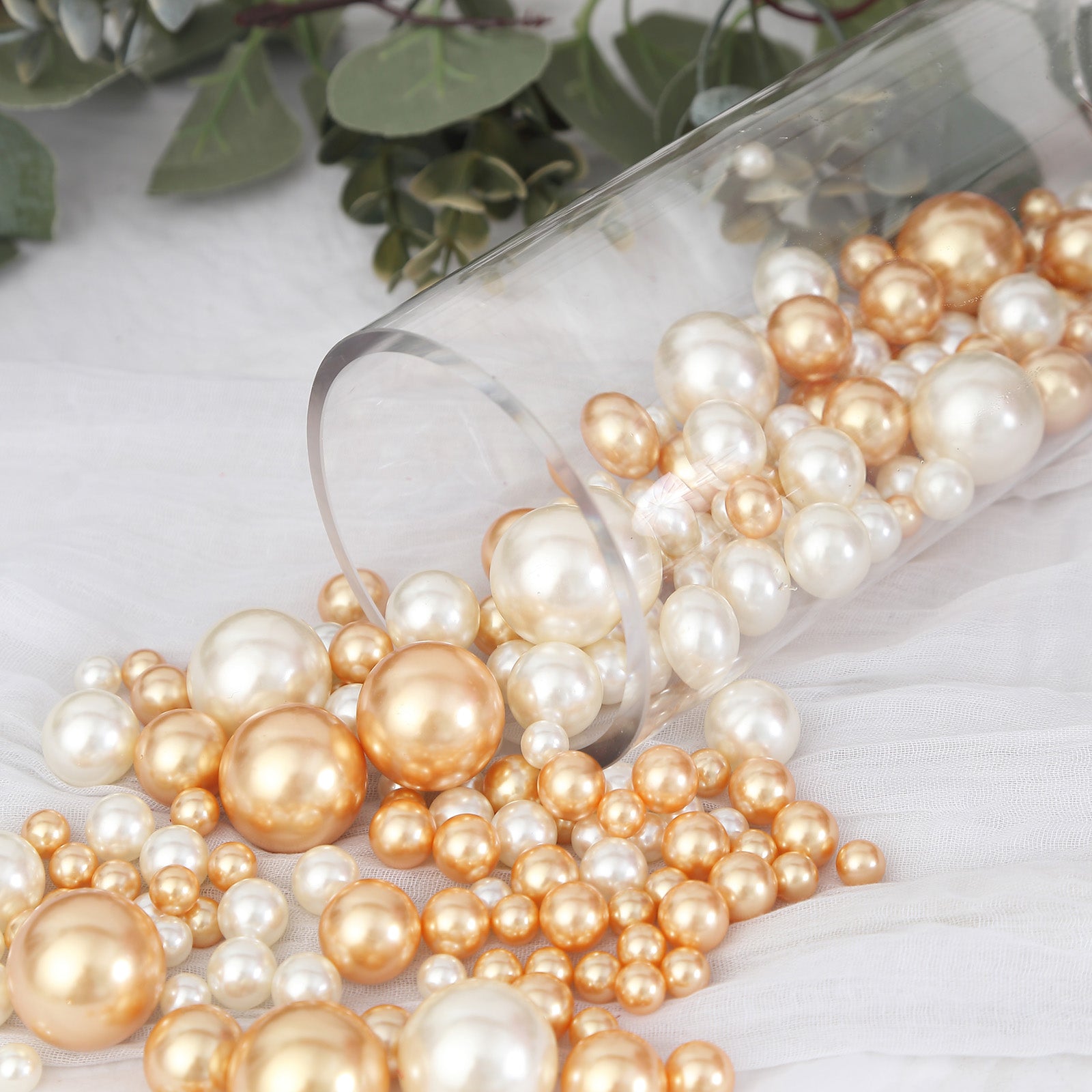 Assorted off white and gold faux pearl beads for DIY crafts.