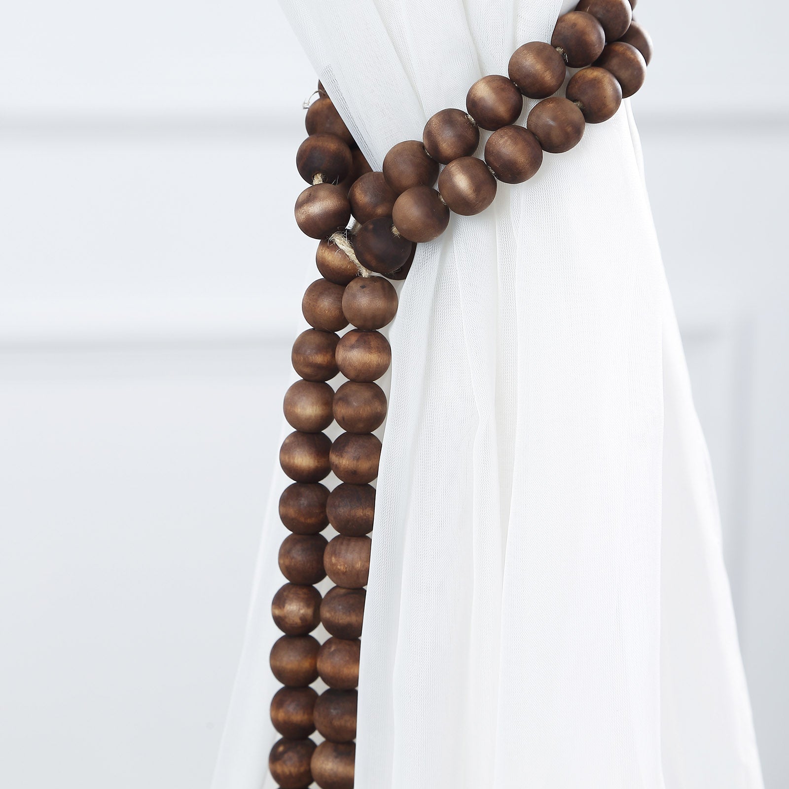 Brown rustic boho chic wood bead garland with tassels.