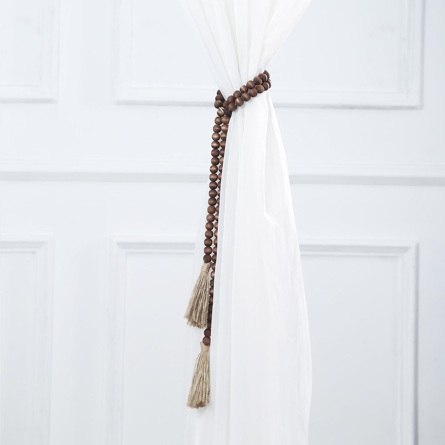 Brown rustic boho chic wood bead garland with tassels.