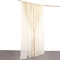 Beige chiffon curtain drapes hanging from a rod.