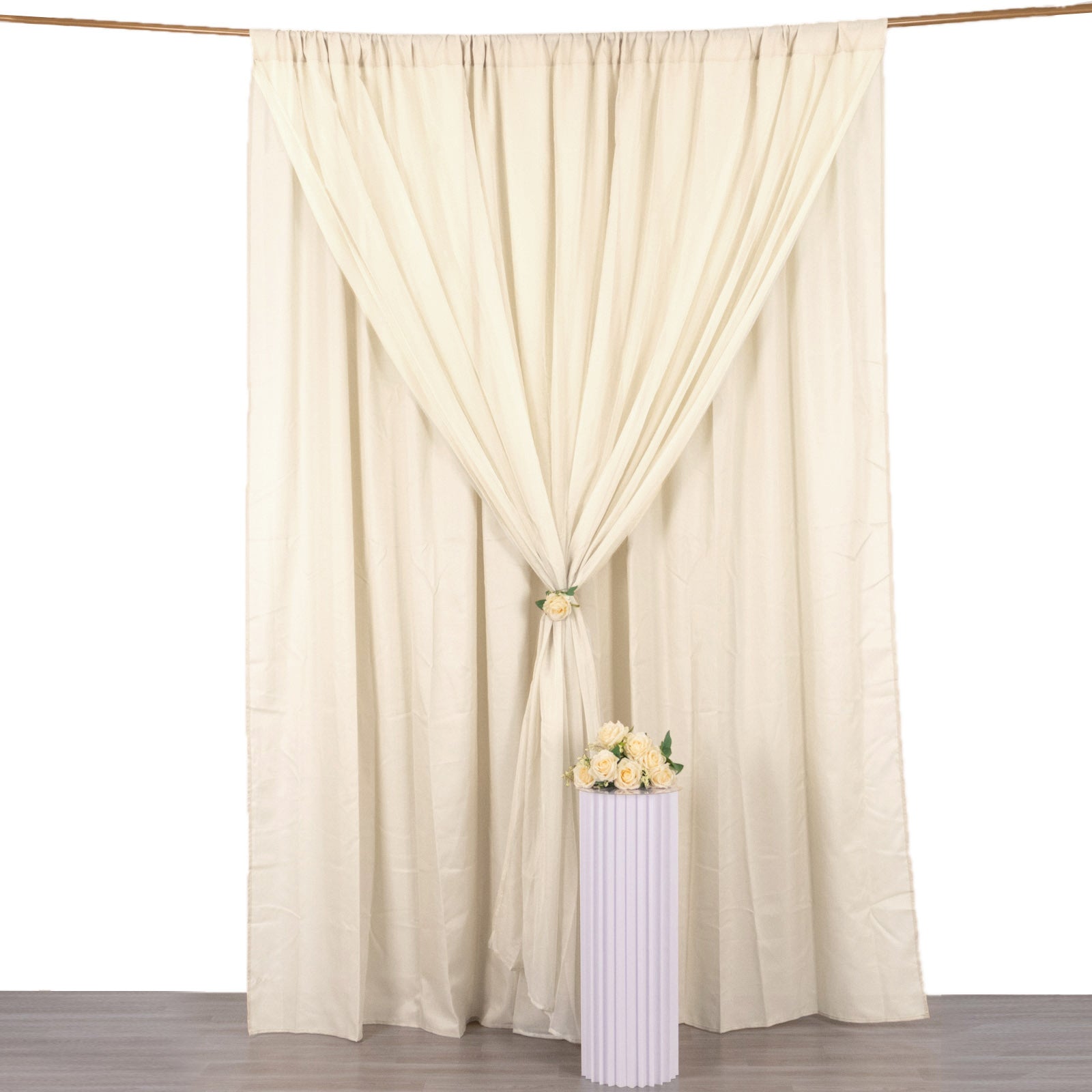 Beige chiffon polyester event curtain drapes hanging elegantly.