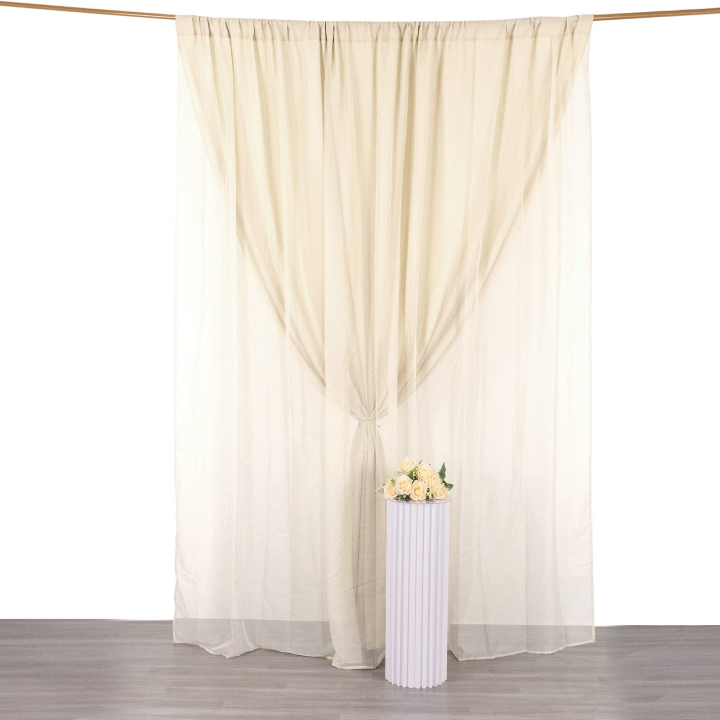 Beige chiffon polyester event curtain drapes backdrop panels.