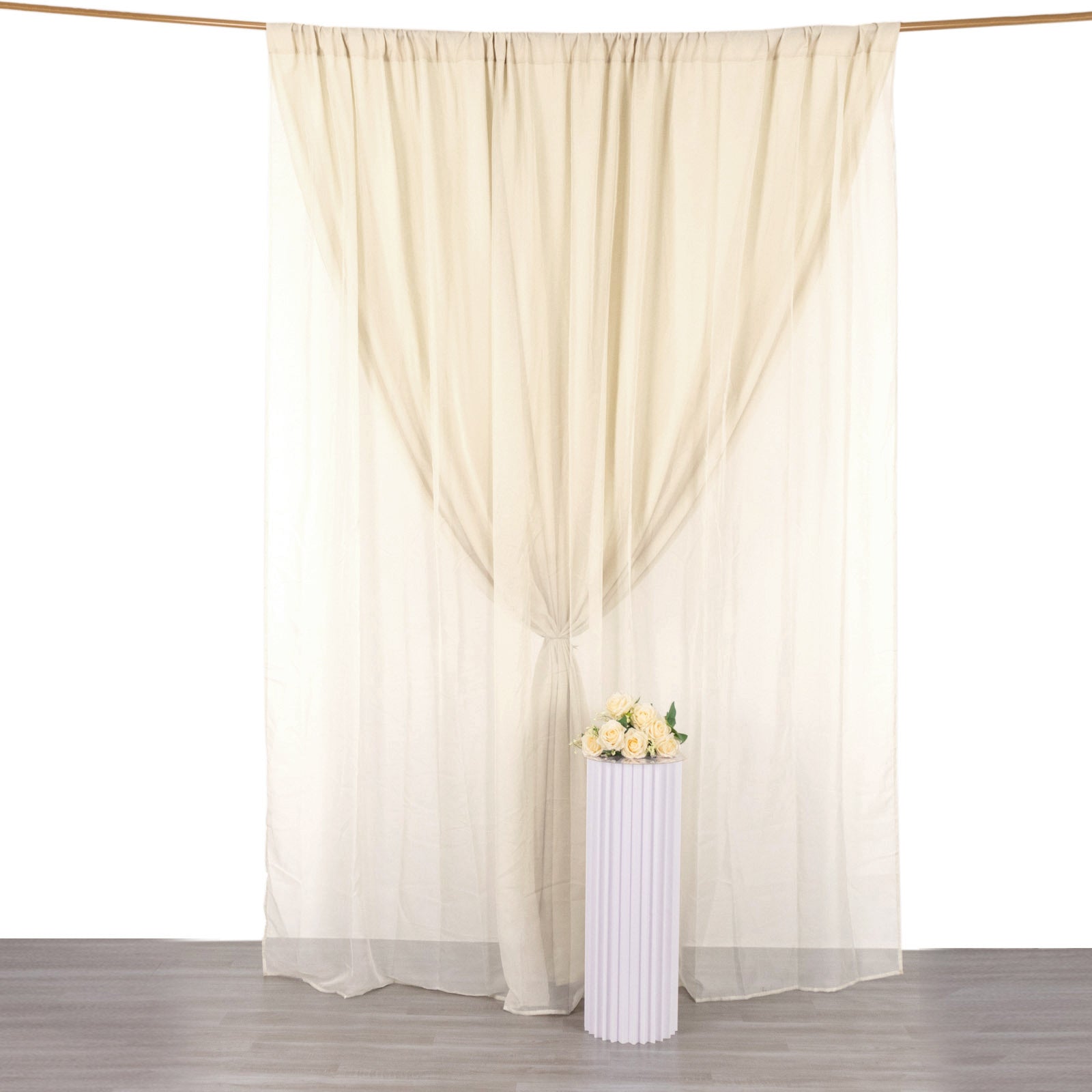 Beige chiffon polyester event curtain drapes backdrop panels.