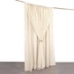 Beige chiffon polyester event curtain drapes on a rod.