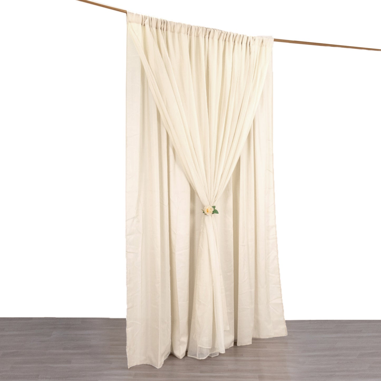 Beige chiffon polyester event curtain drapes on a rod.