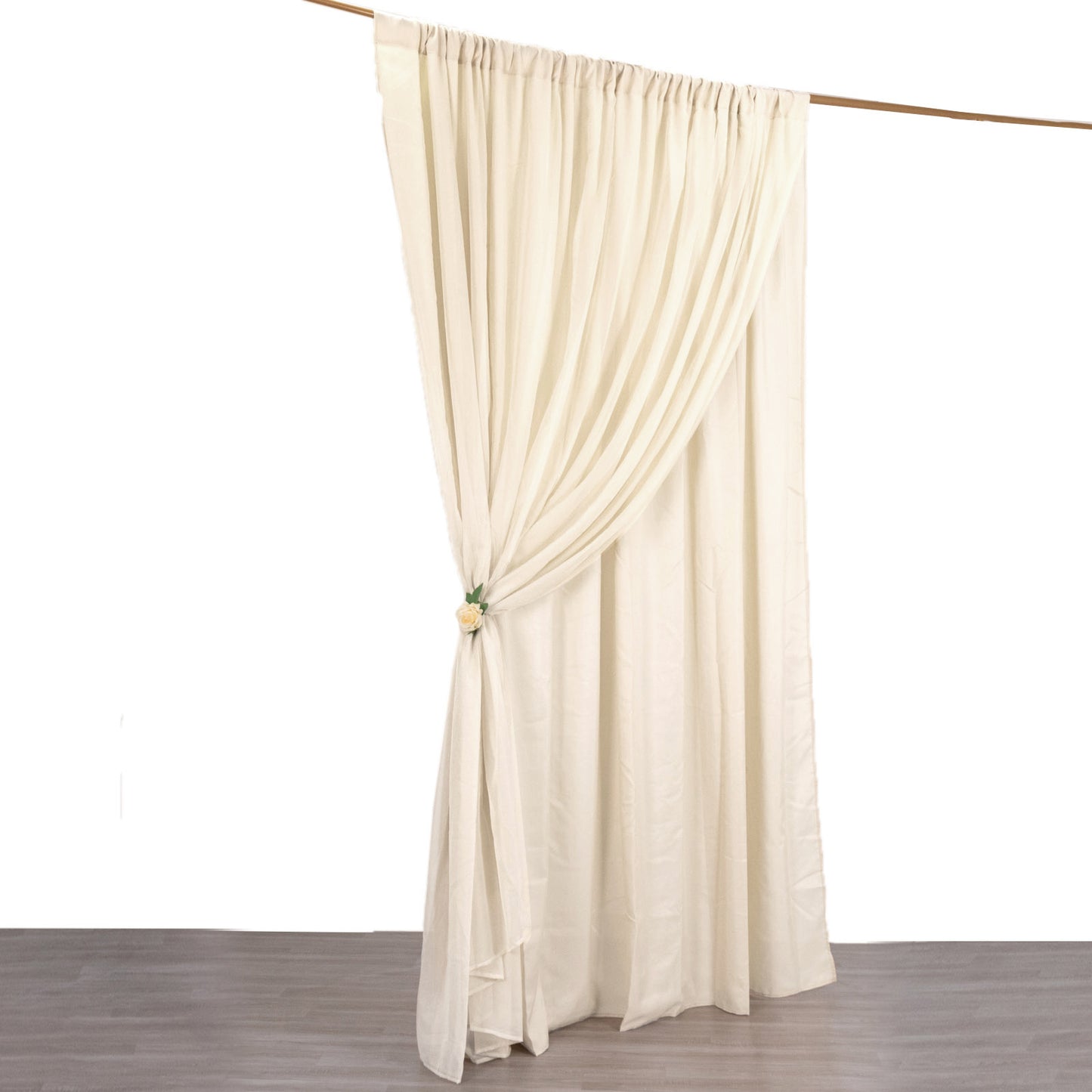 Beige chiffon polyester event curtain drapes hanging on a rod.