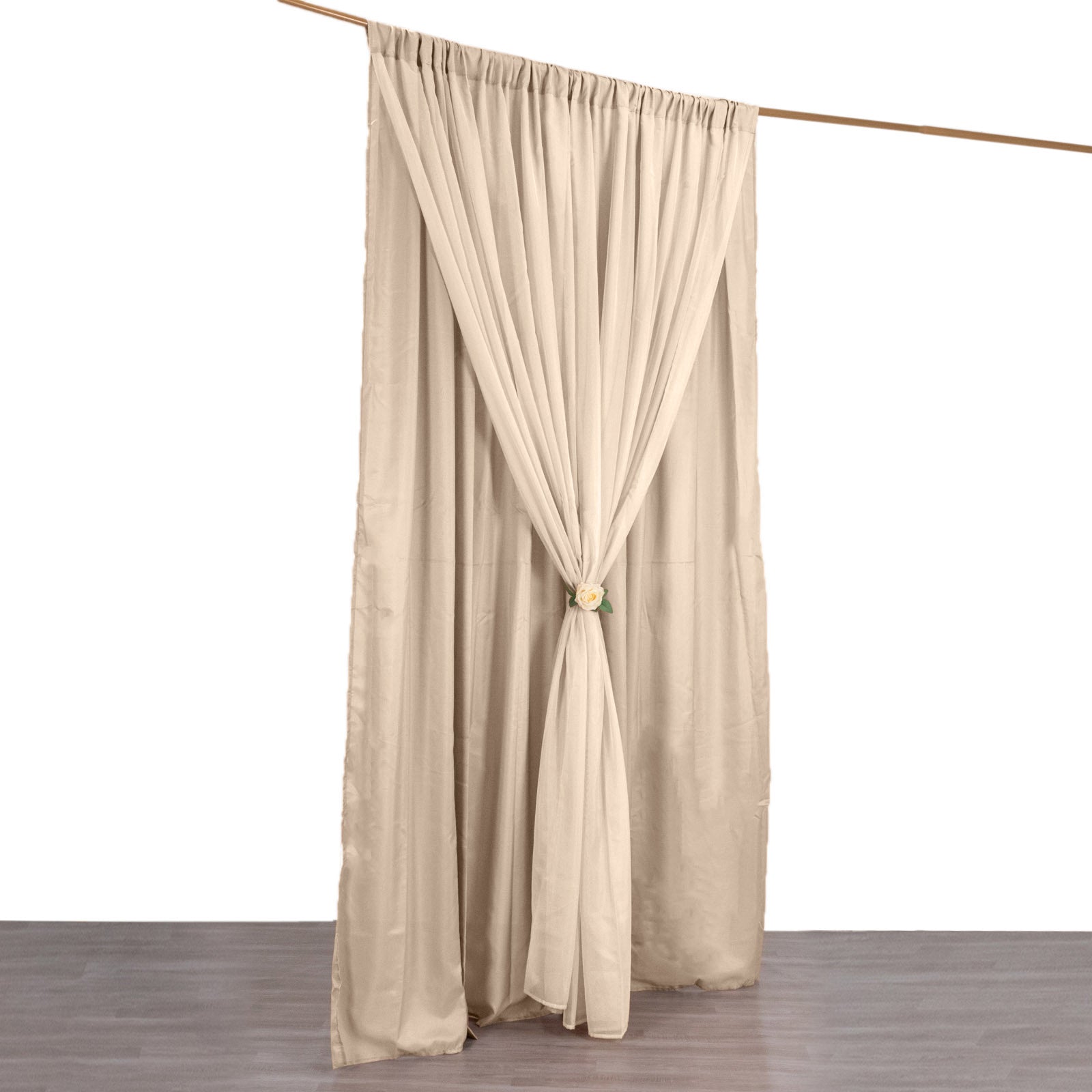 Nude chiffon polyester event curtain drapes on a rod.