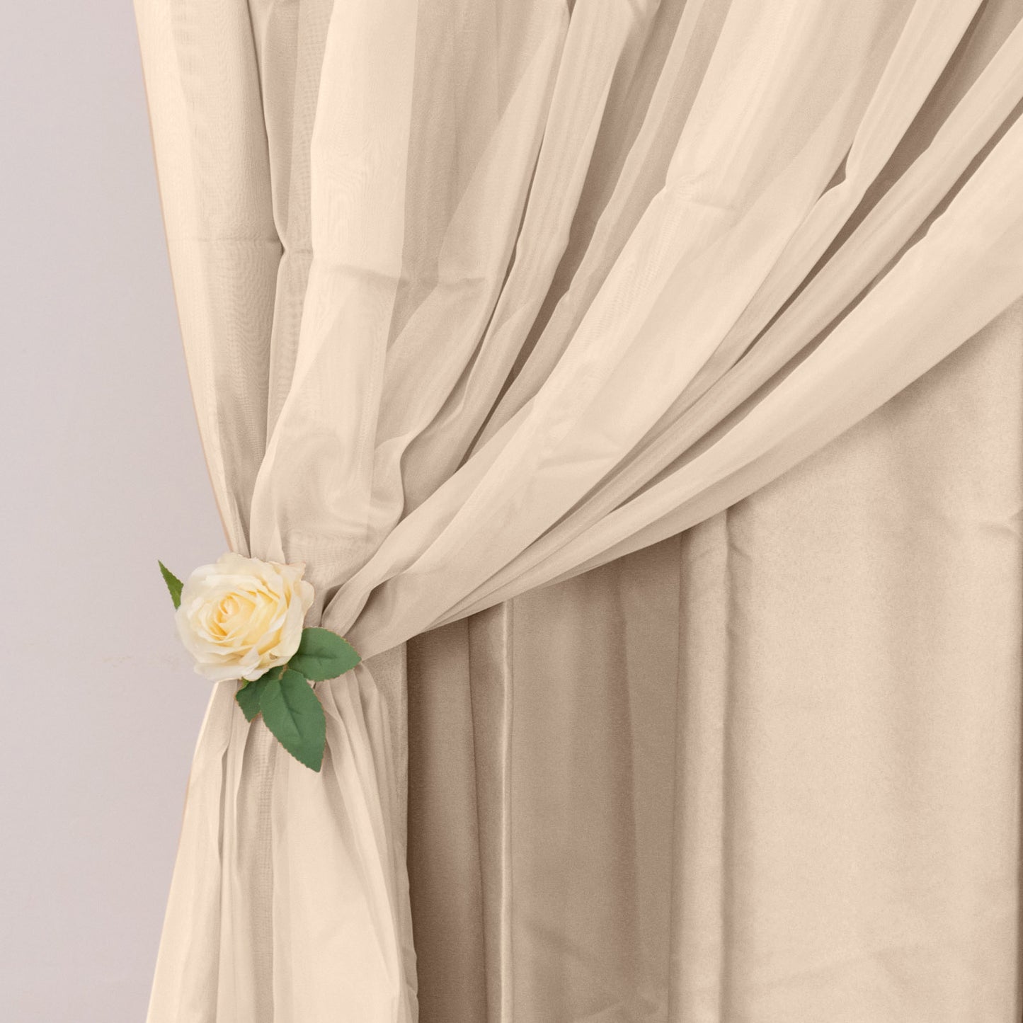 Nude chiffon polyester event curtain drapes with rod pockets.