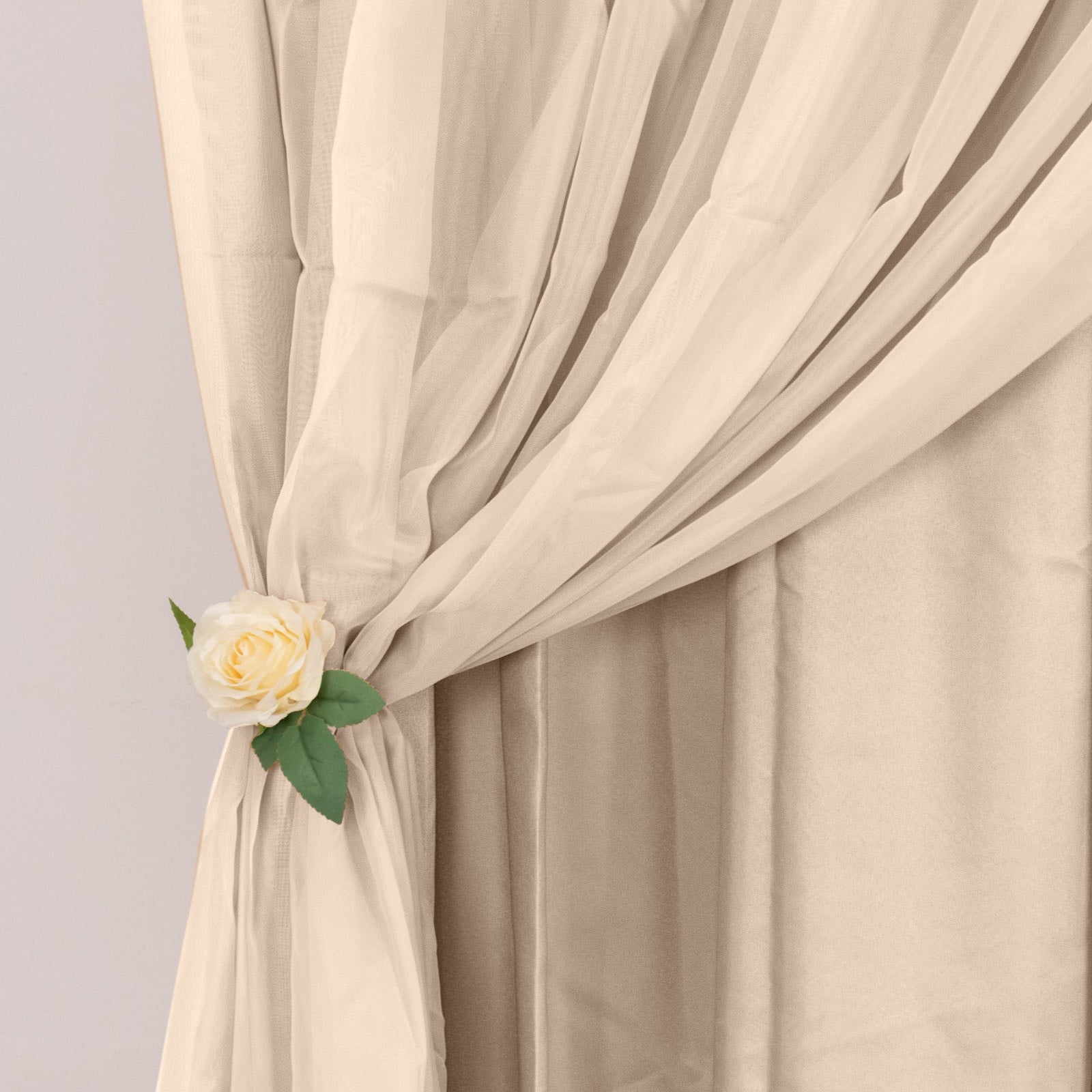Nude chiffon polyester event curtain drapes with rod pockets.