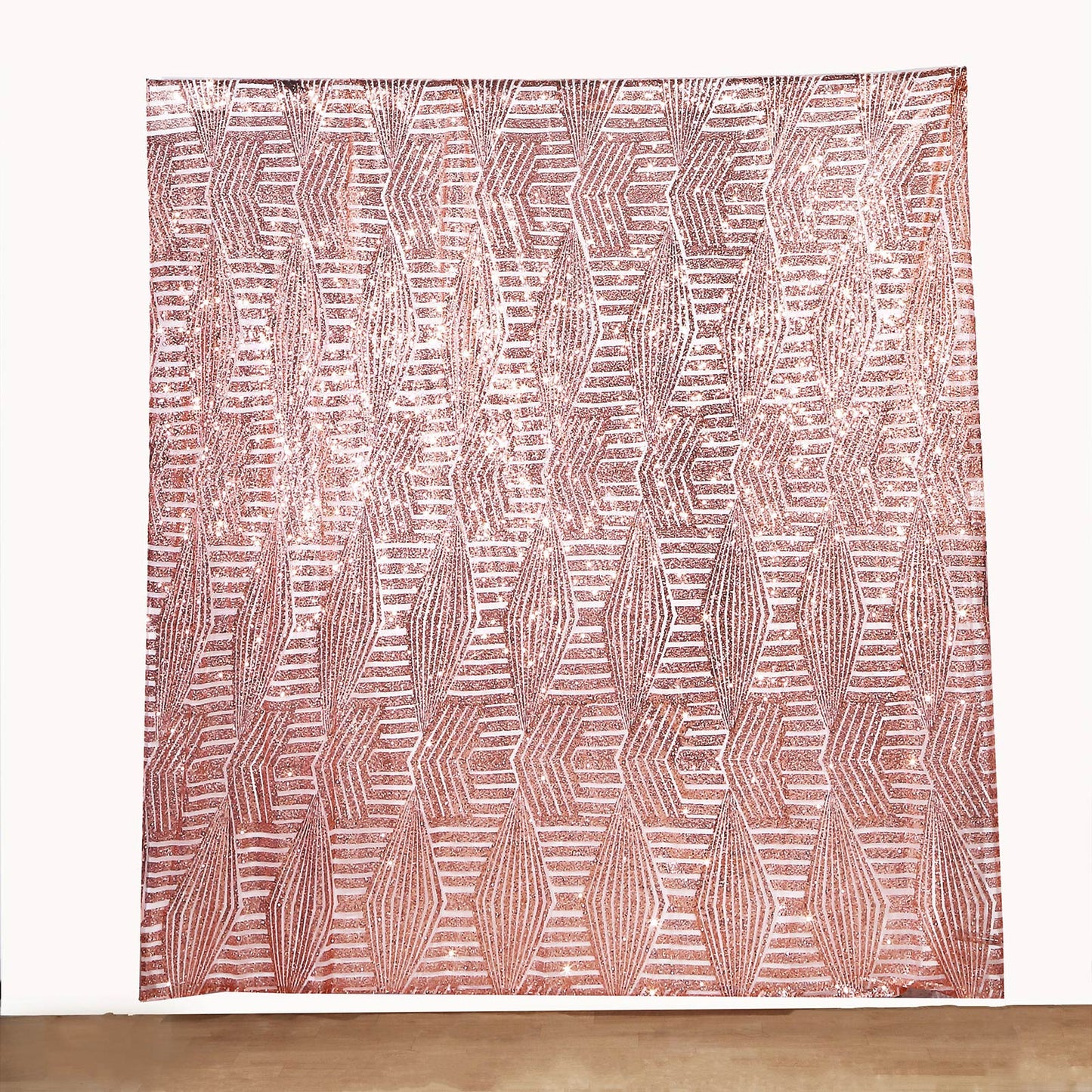 Rose gold geometric sequin backdrop curtain with satin backing.