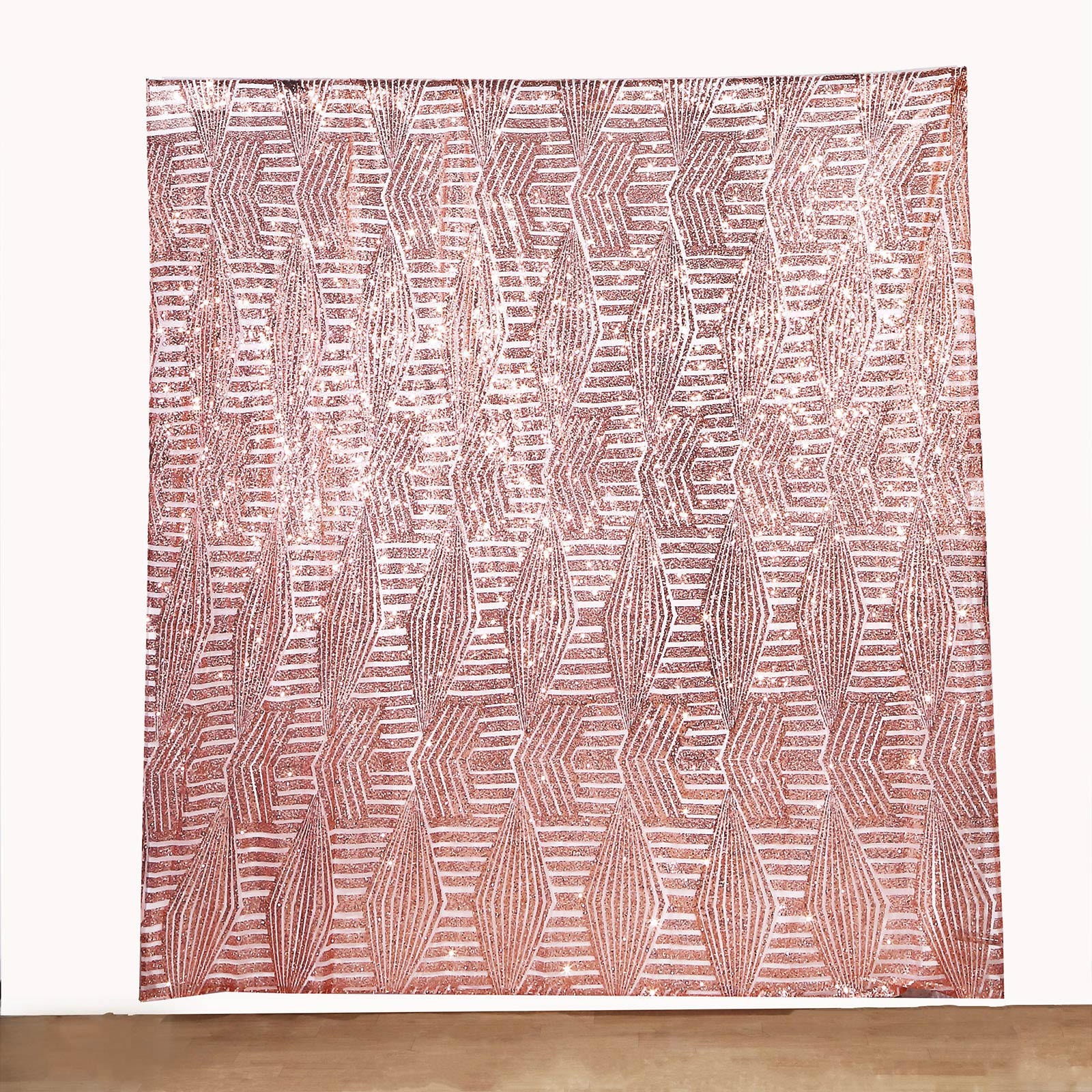 Rose gold geometric sequin backdrop curtain with satin backing.