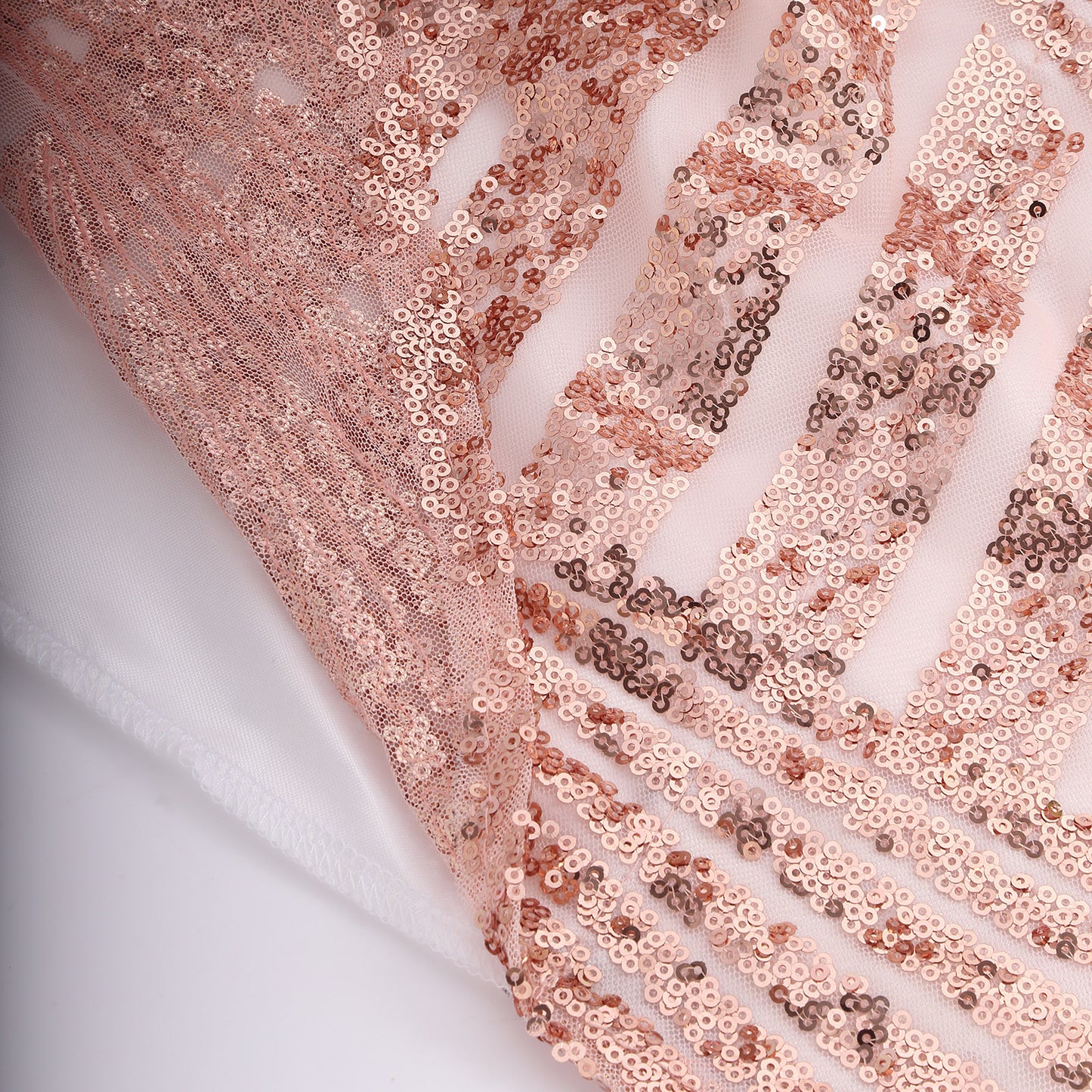 Rose gold geometric sequin curtain drapes with satin backing.