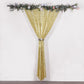 Gold sequin event curtain drapes with satin backing and floral decor.