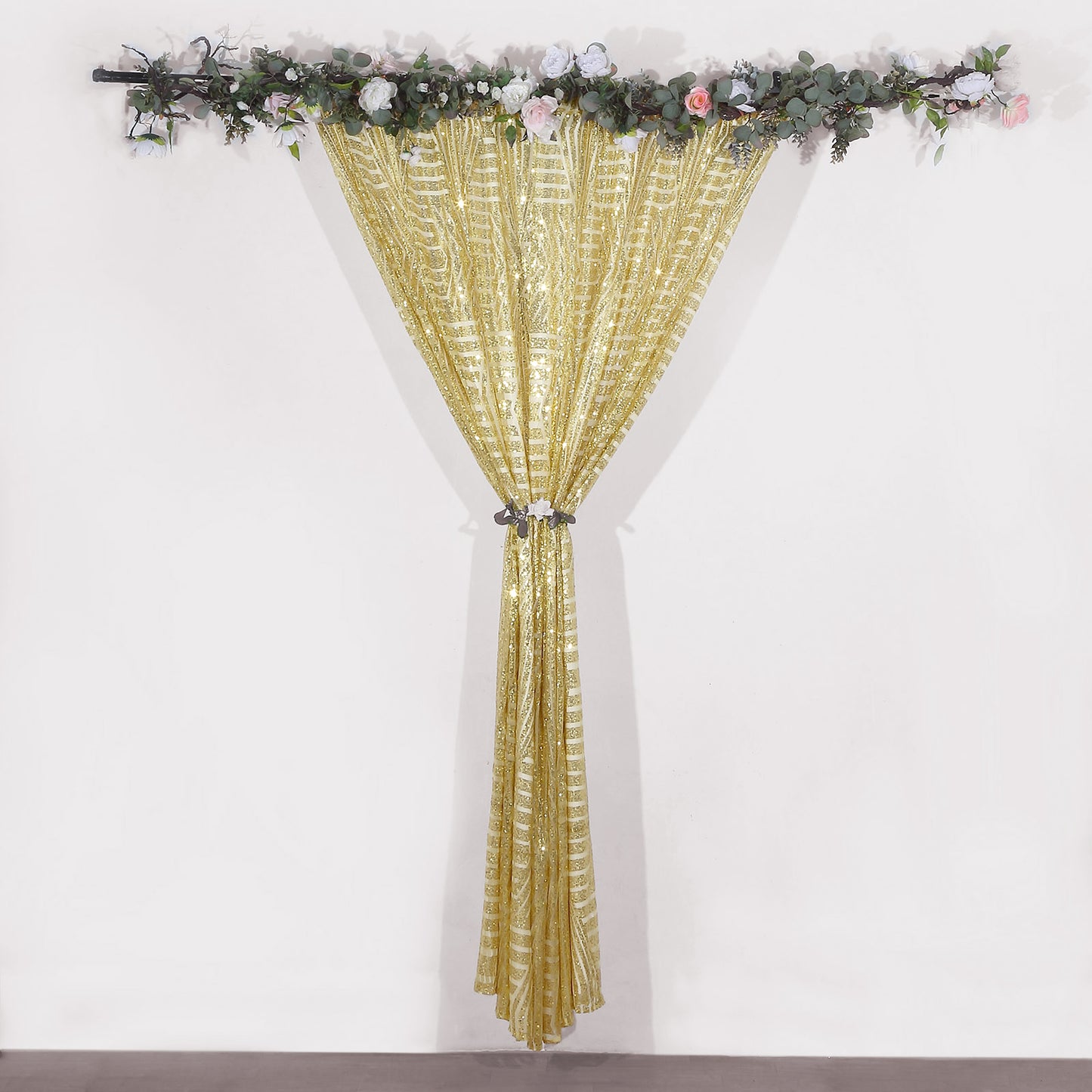 Gold sequin event curtain drapes with satin backing and floral decor.