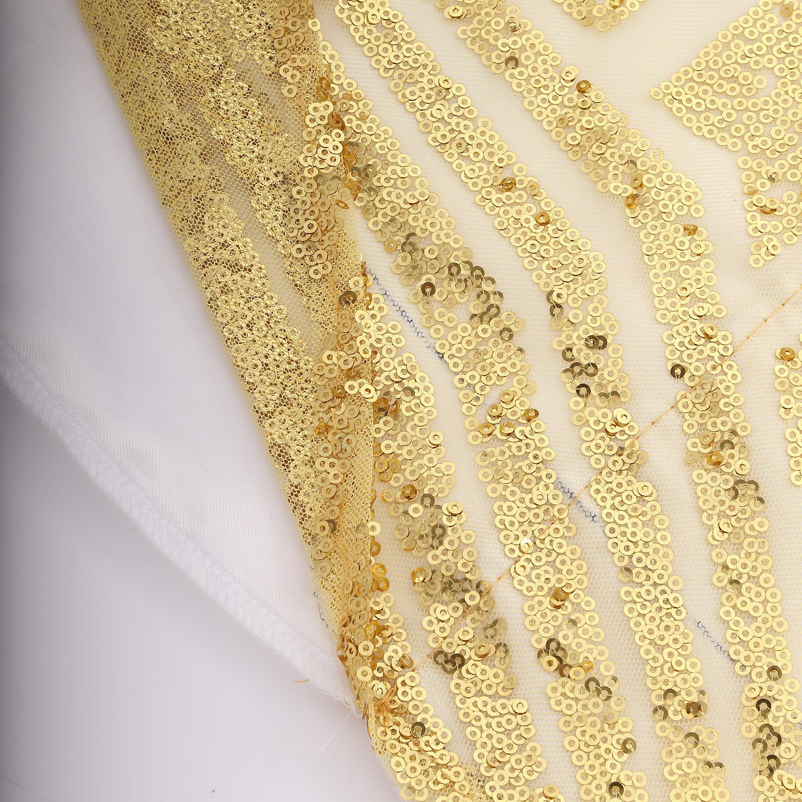 Gold geometric sequin curtain drapes with satin backing in diamond glitz pattern.
