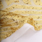 Gold geometric sequin backdrop drapes with satin backing.