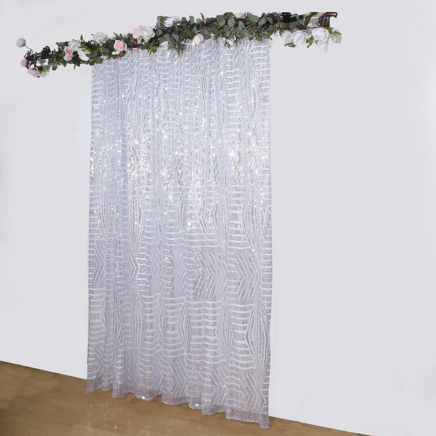 Silver geometric sequin event curtain drapes with satin backing.