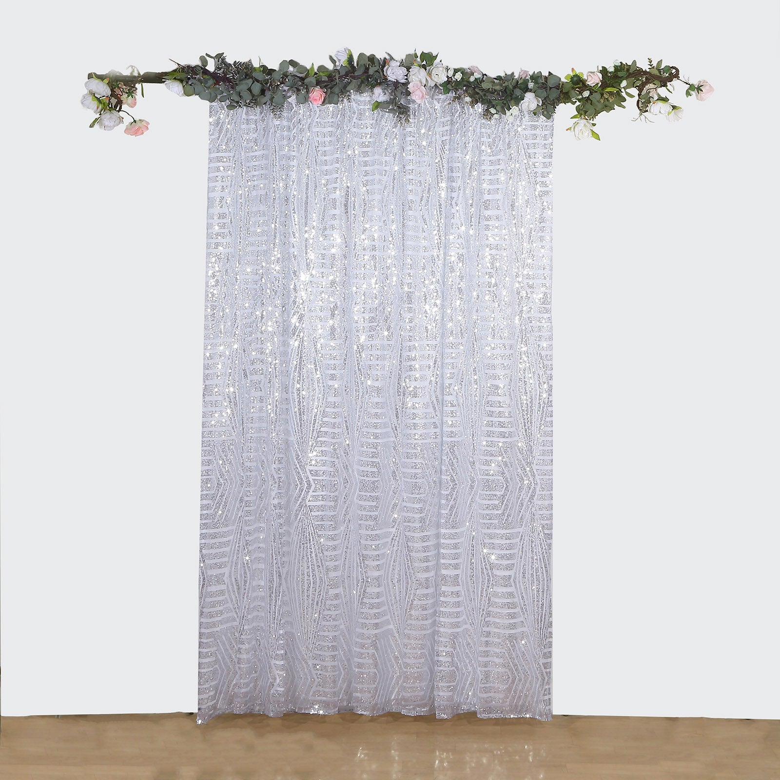 Silver geometric sequin backdrop curtain drapes with satin backing.