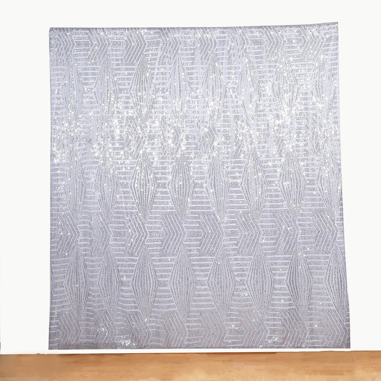 Silver geometric sequin event curtain drapes with satin backing.