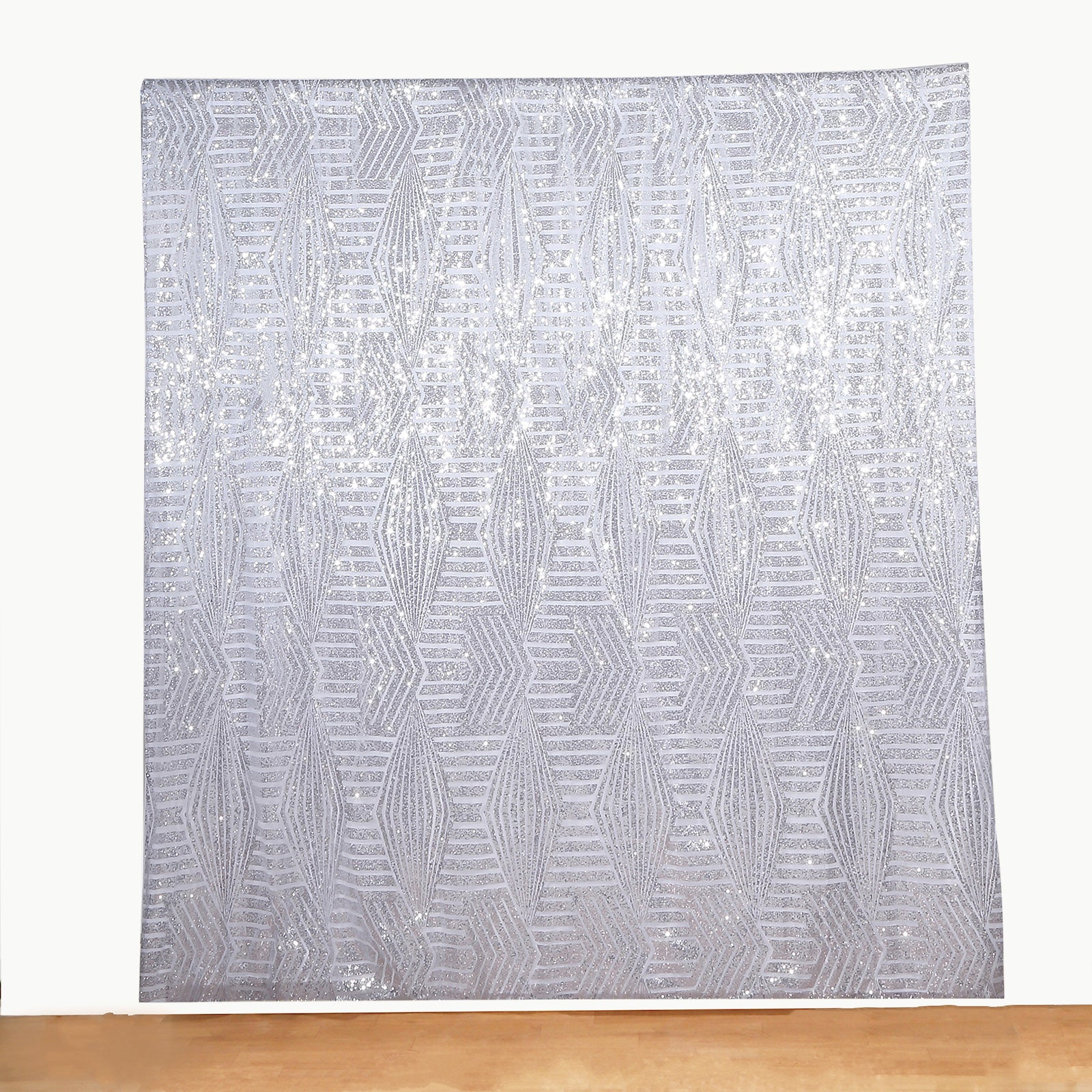 Silver geometric sequin event curtain drapes with satin backing.