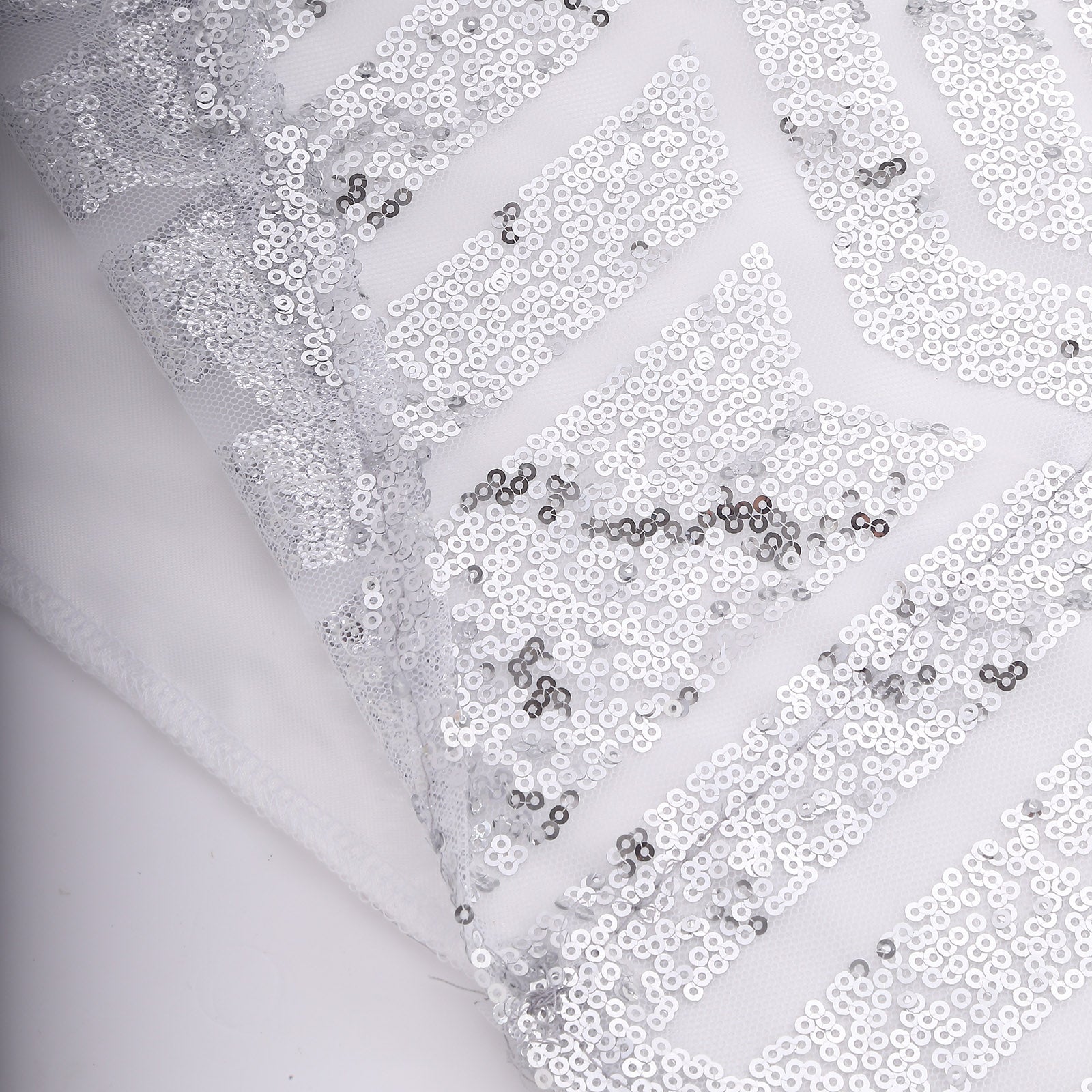 Silver geometric sequin event curtain drapes with satin backing.
