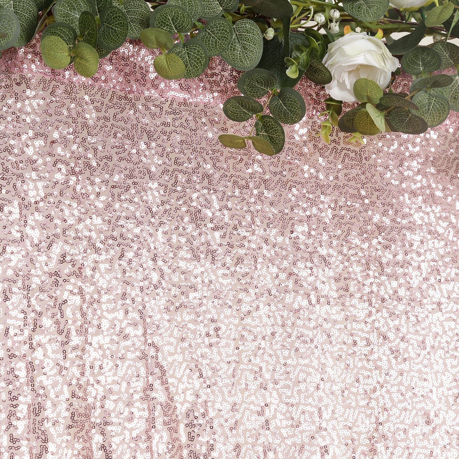 Pink sequin backdrop curtain with shimmering drape for events and photo booths.