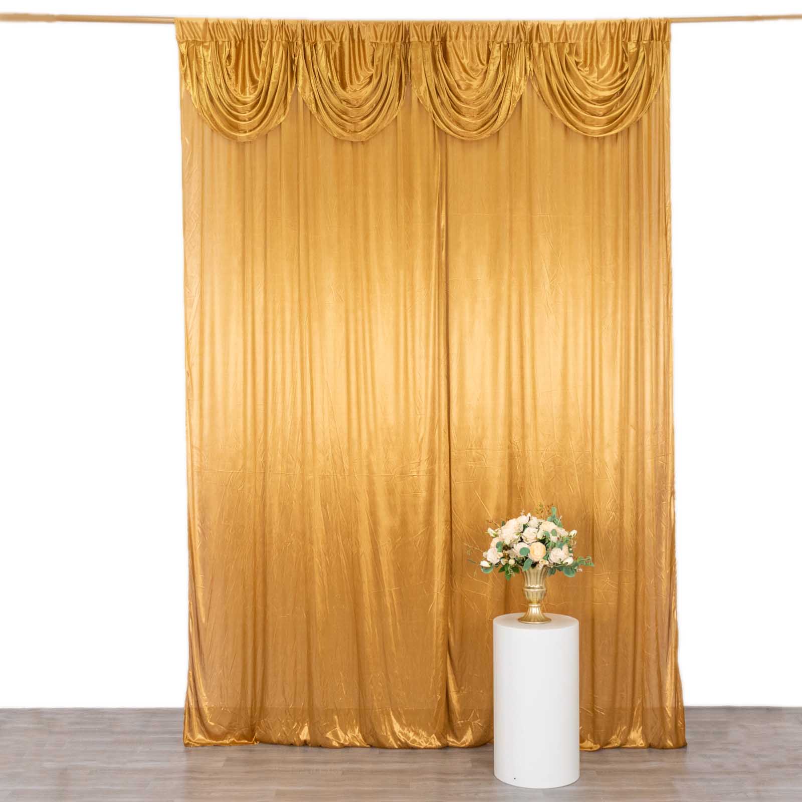 Gold pleated satin drapes for events, glossy backdrop panel.