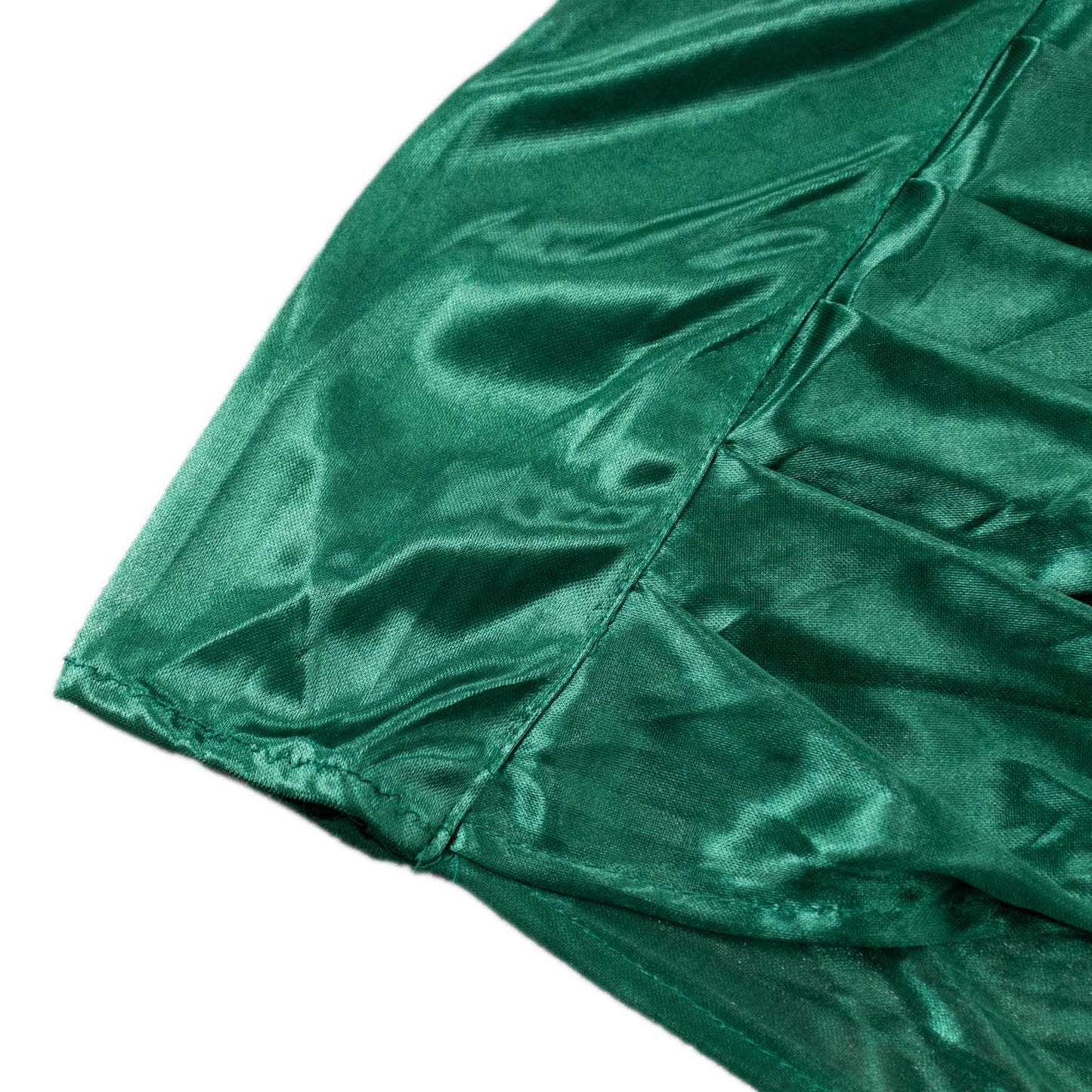Emerald green pleated satin event curtain drapes for glossy photo backdrop.