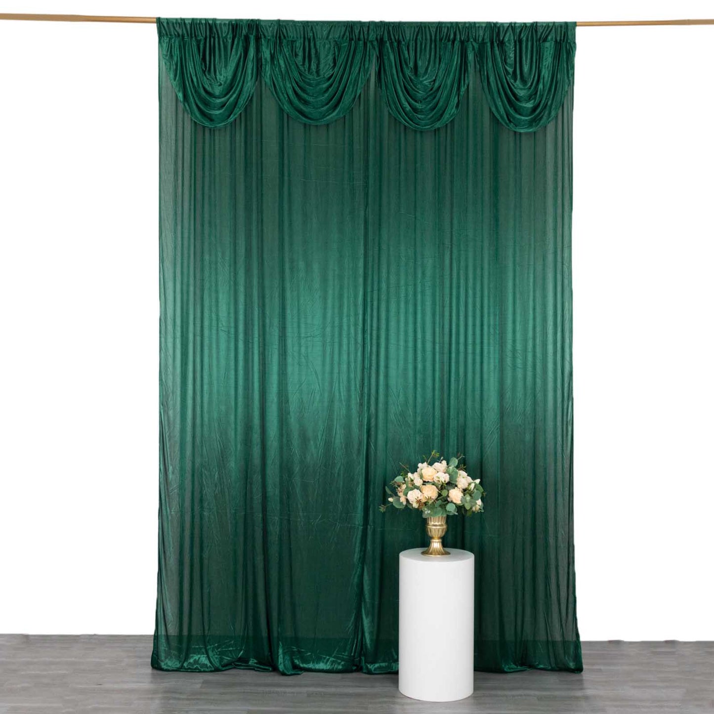 Emerald green pleated satin event curtain drapes backdrop.