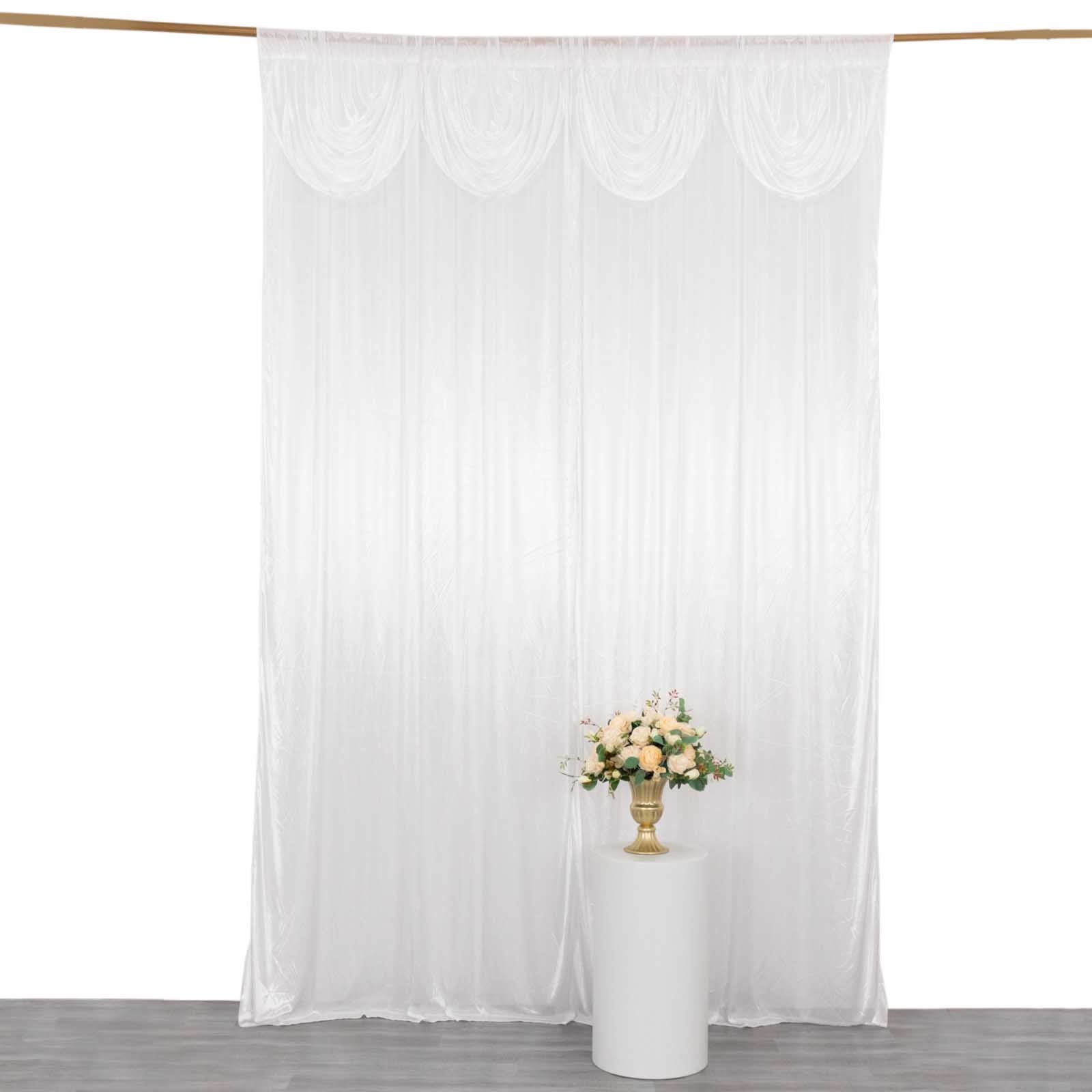 White satin event curtain drapes with pleats, glossy backdrop for photos.