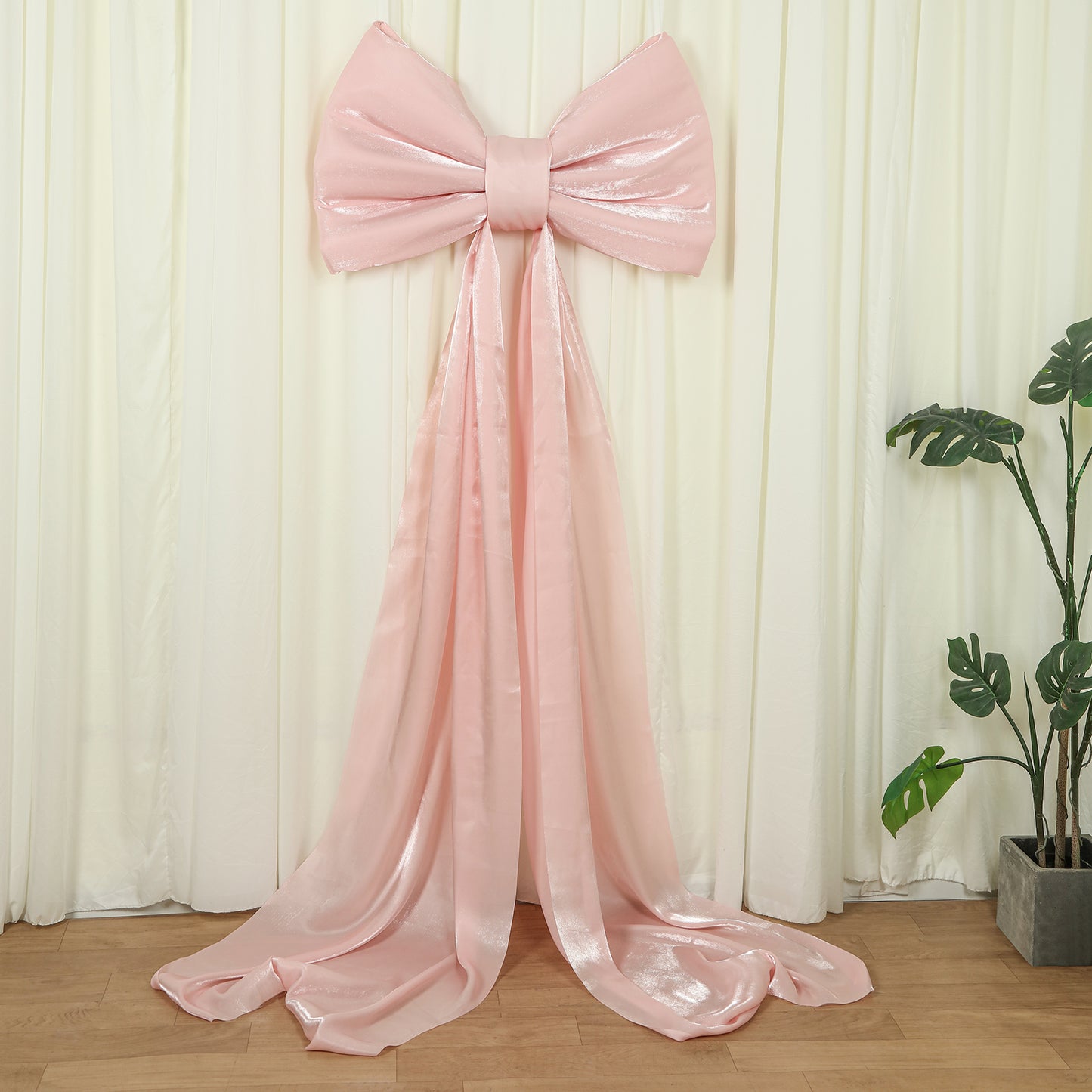 Blush pink giant bow tie décor for wedding and event backdrops.