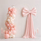 Blush pink bow tie décor for wedding and event backdrops.