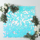Iridescent blue sequin shimmer wall backdrop with mermaid scales pattern.