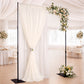 Black heavy duty metal backdrop stand with drapery and floral arrangement.