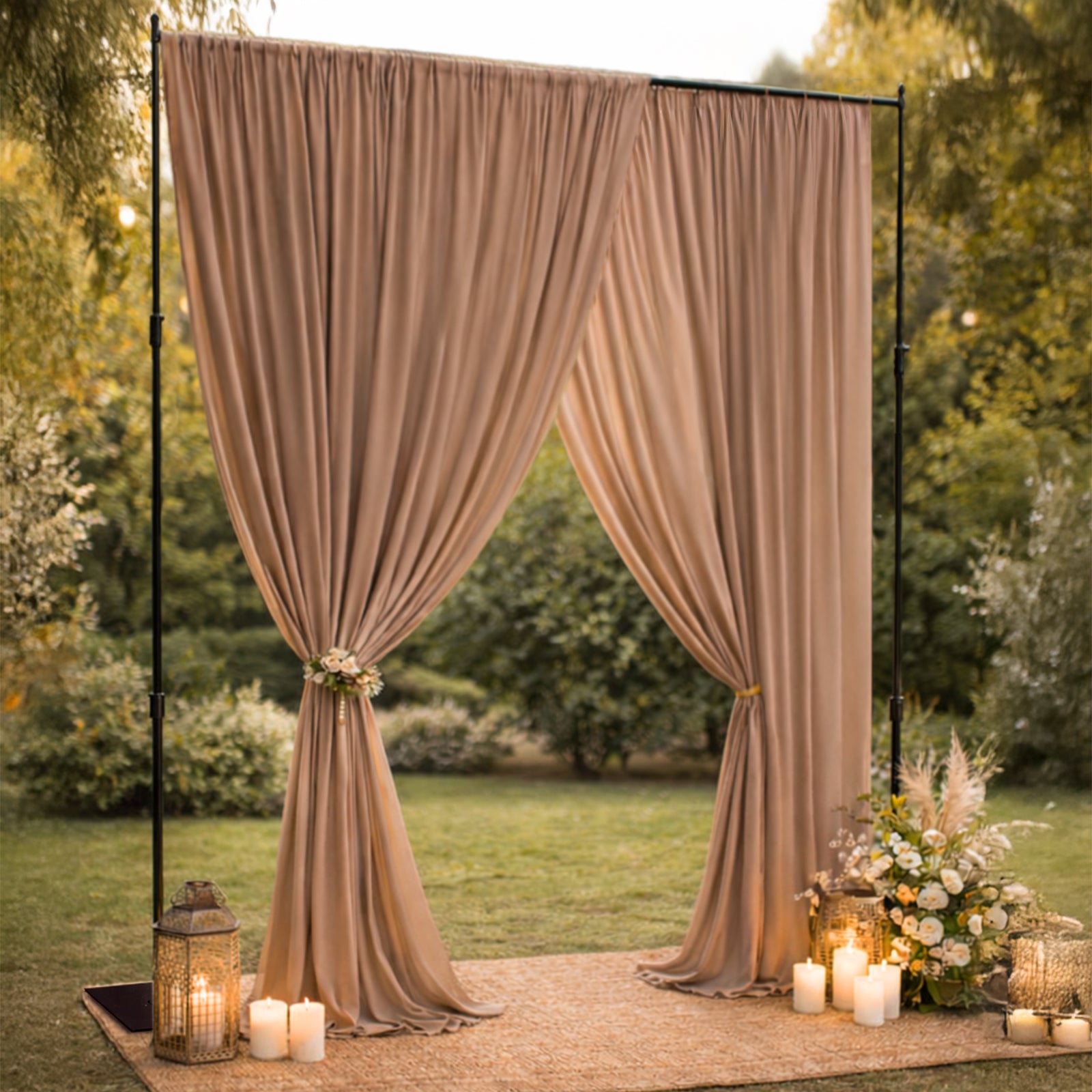 Black metal backdrop stand with draped fabric and decorative elements.