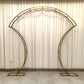 Gold double-curved metal arch frame for backdrops and displays.