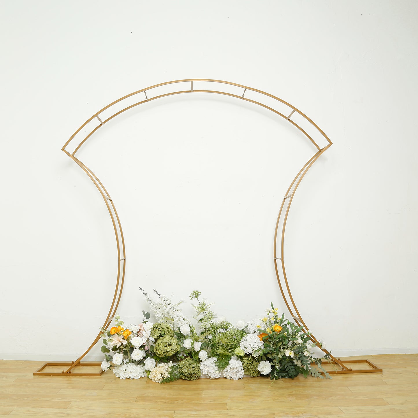 7ft gold double-curved metal arch frame with floral arrangement display.