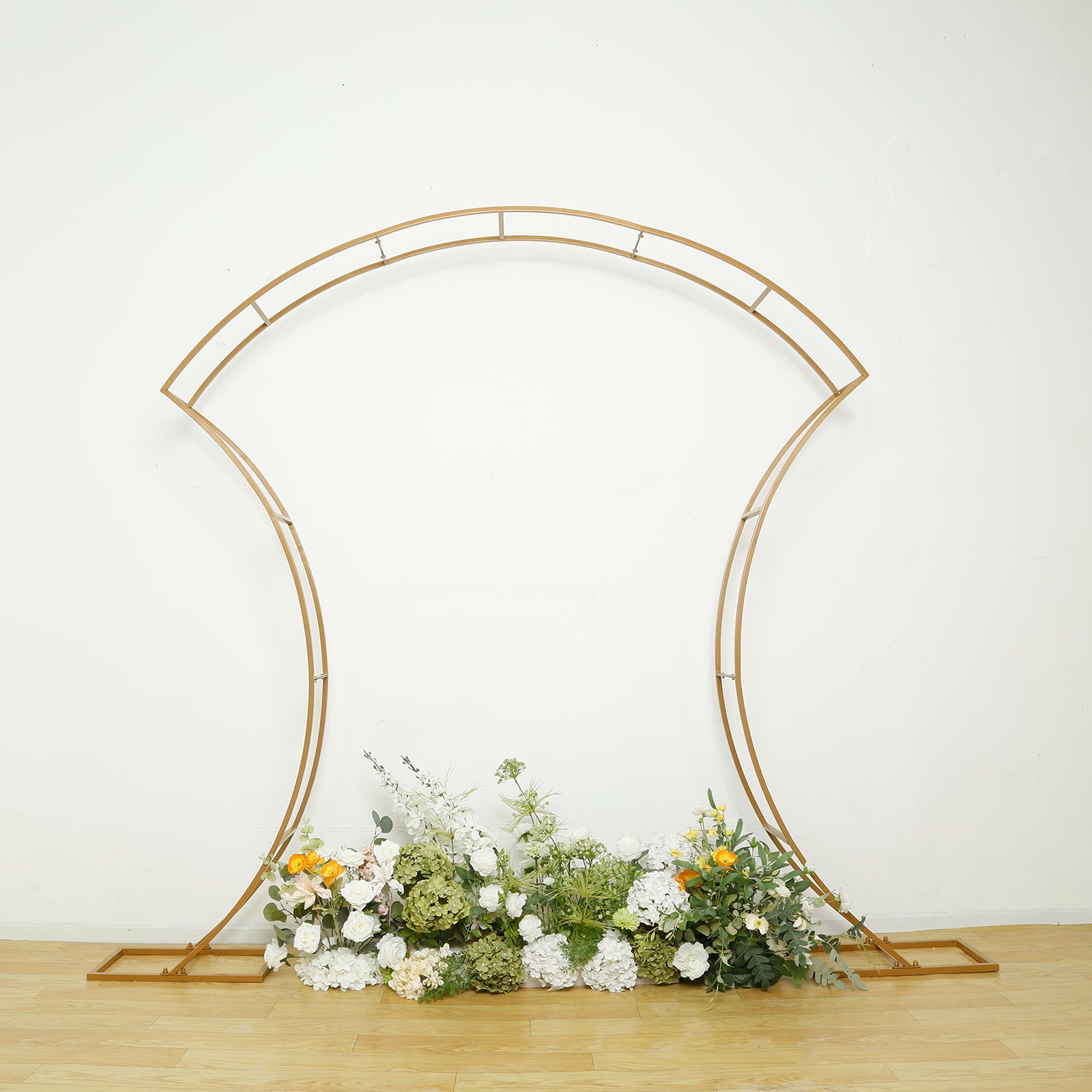 7ft gold double-curved metal arch frame with floral arrangement display.