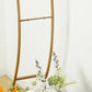 Gold metal arch frame for balloon and flower arrangements display.