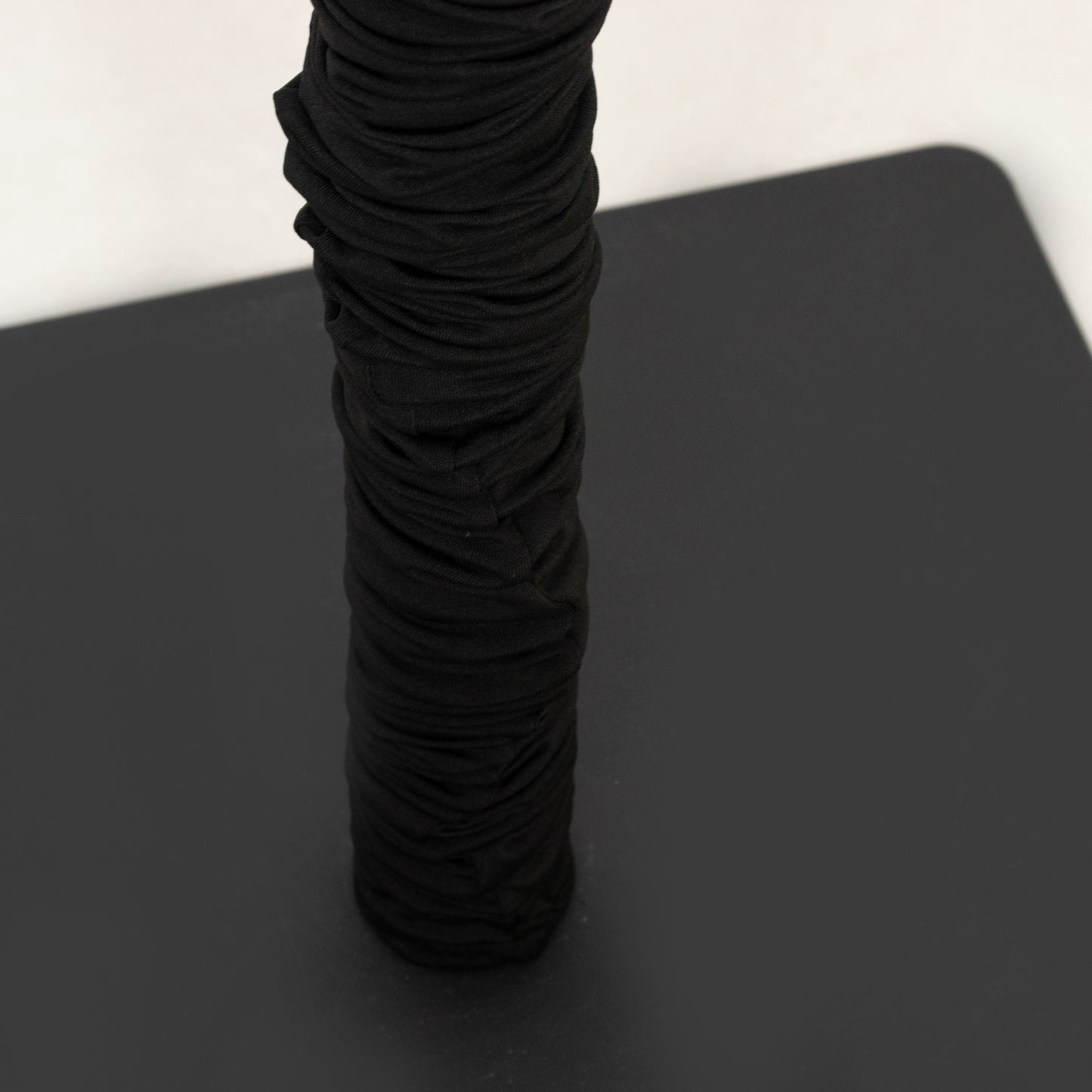 Black spandex pole cover for event setup and lighting use.