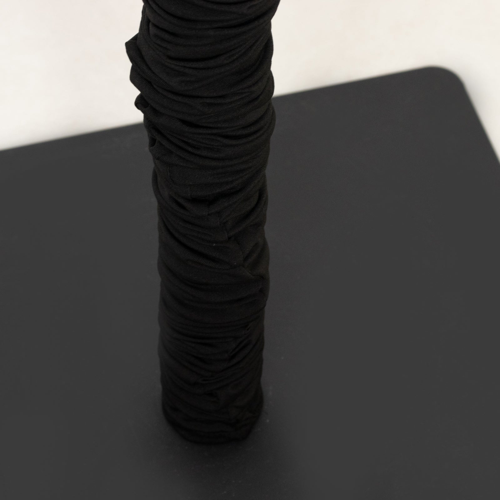 Black spandex pole cover for event setup and lighting use.