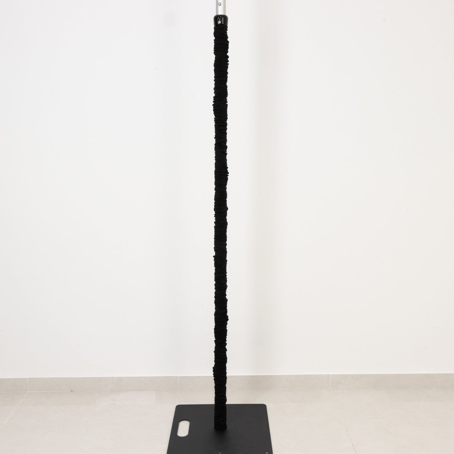 Black spandex upright pole cover for event setup and lighting use.