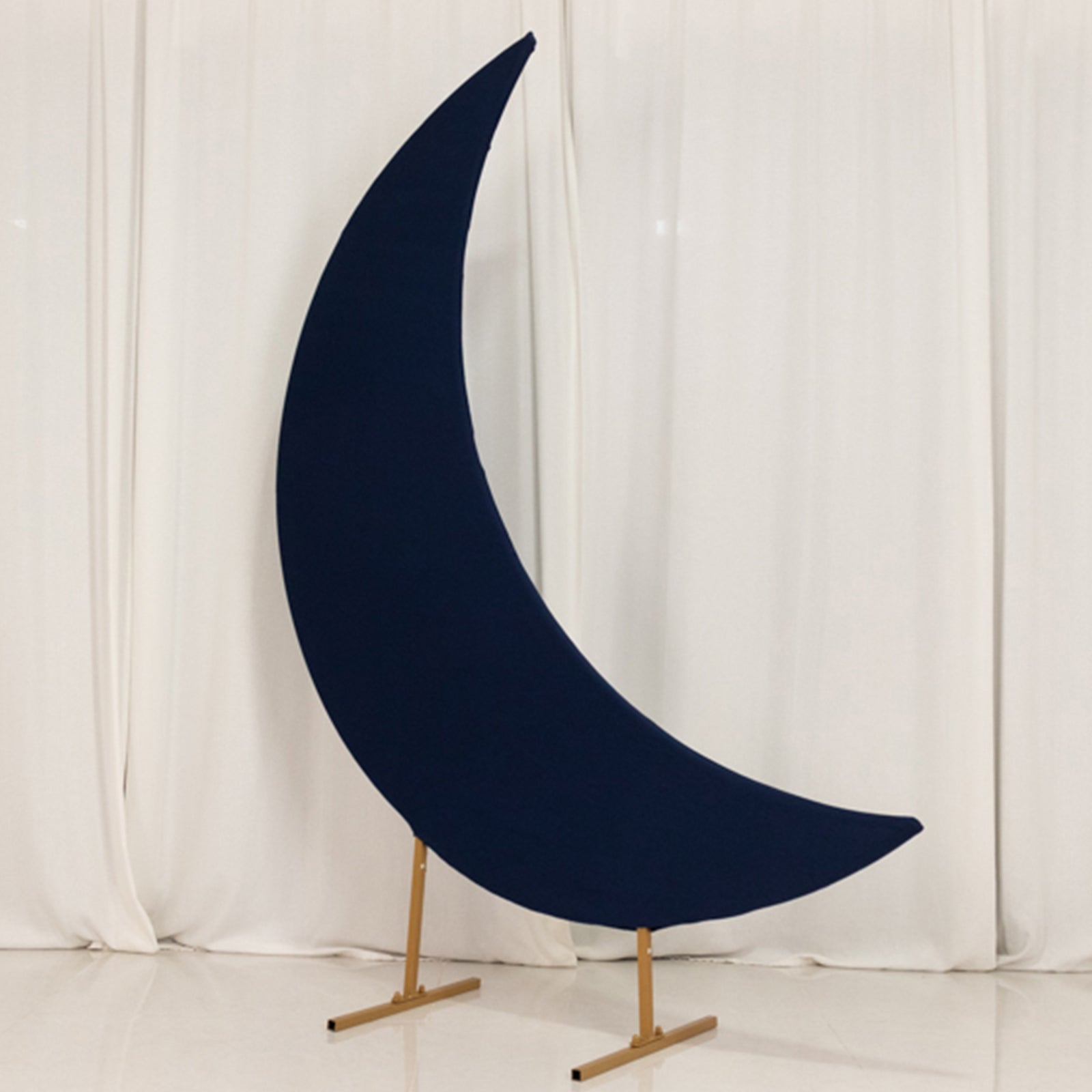 Navy blue spandex crescent moon backdrop stand for weddings.